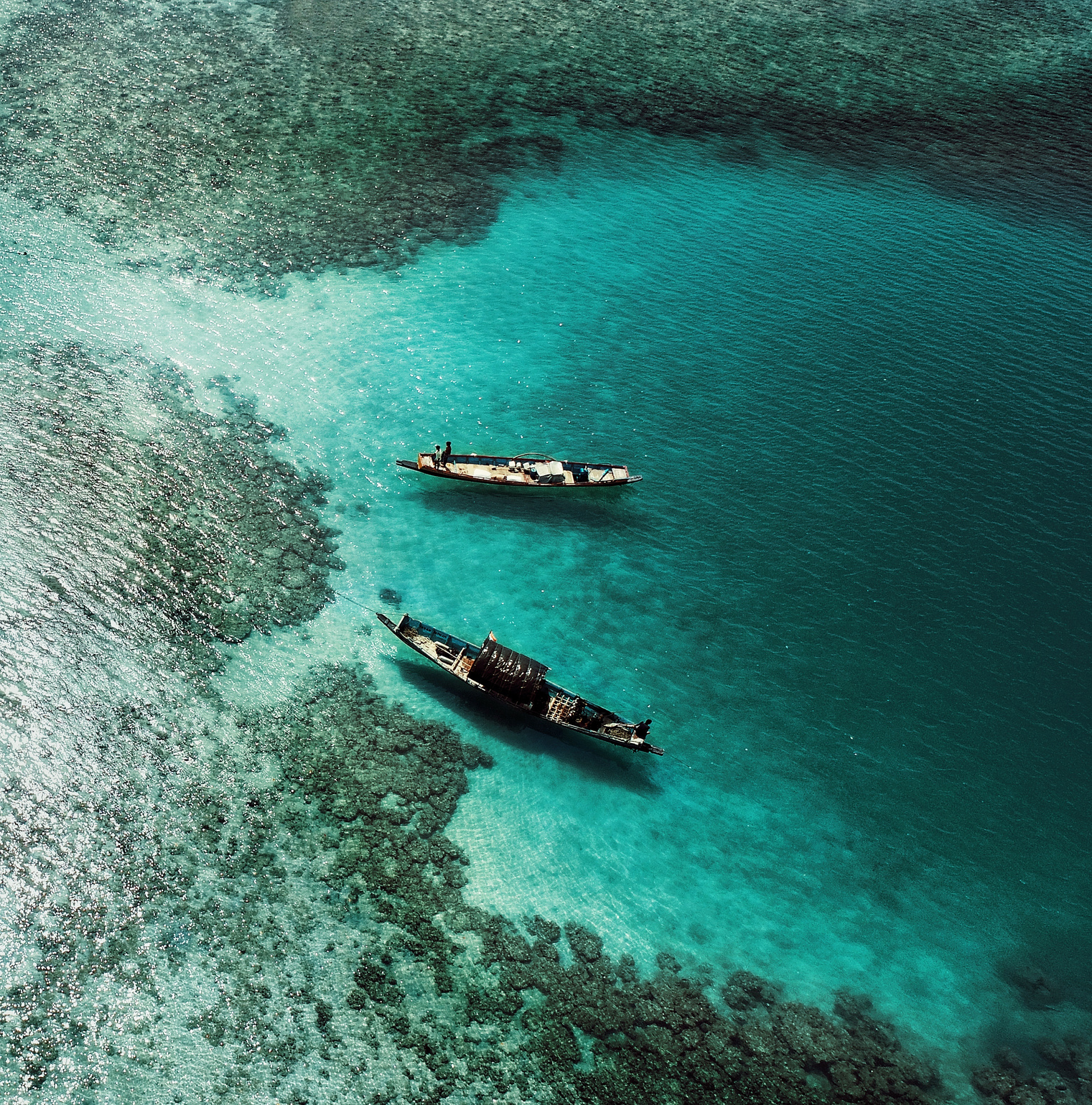 Boats floating on rippling transparent water of lagoon